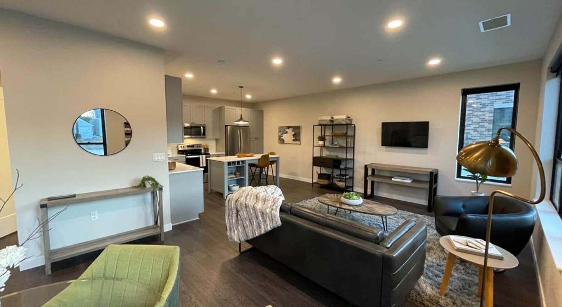 Living room with couch coffee table and wall mounted tv