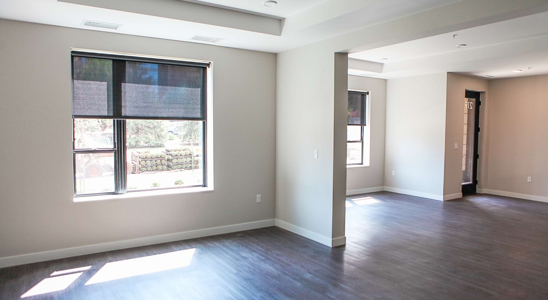 empty room with wood floors and window